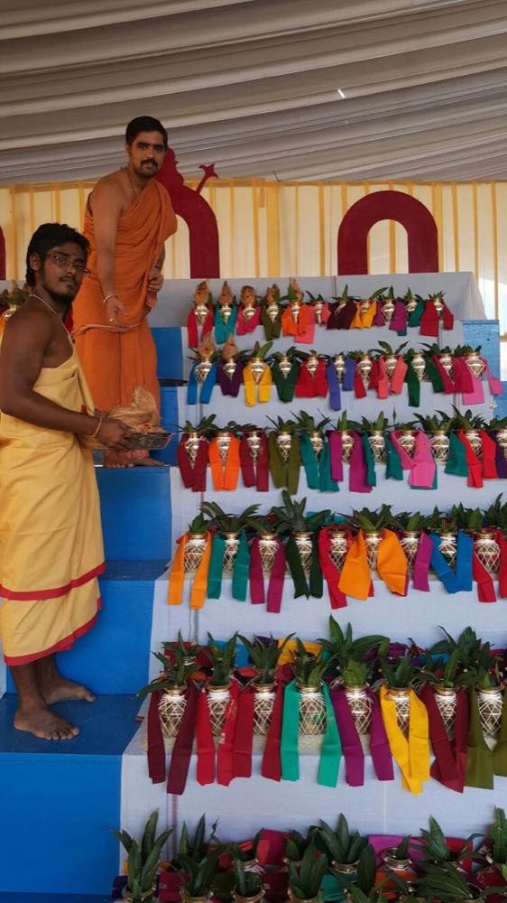 Rows of kalashas wrapped in coloured cloth on tiered steps